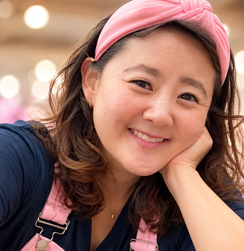 Sarah smiling, wearing a pink headband